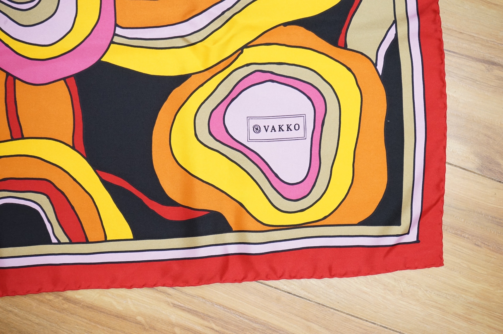 Three silk scarves comprising a Burberry check example, Christian Dior monogrammed and a Vakko abstract patterned example